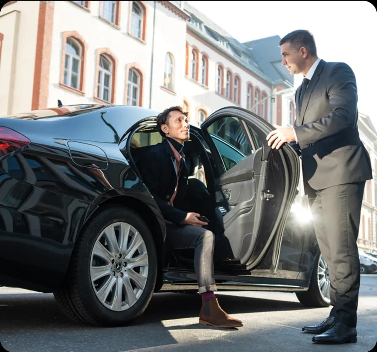 Chauffeur opening the door of an executive car