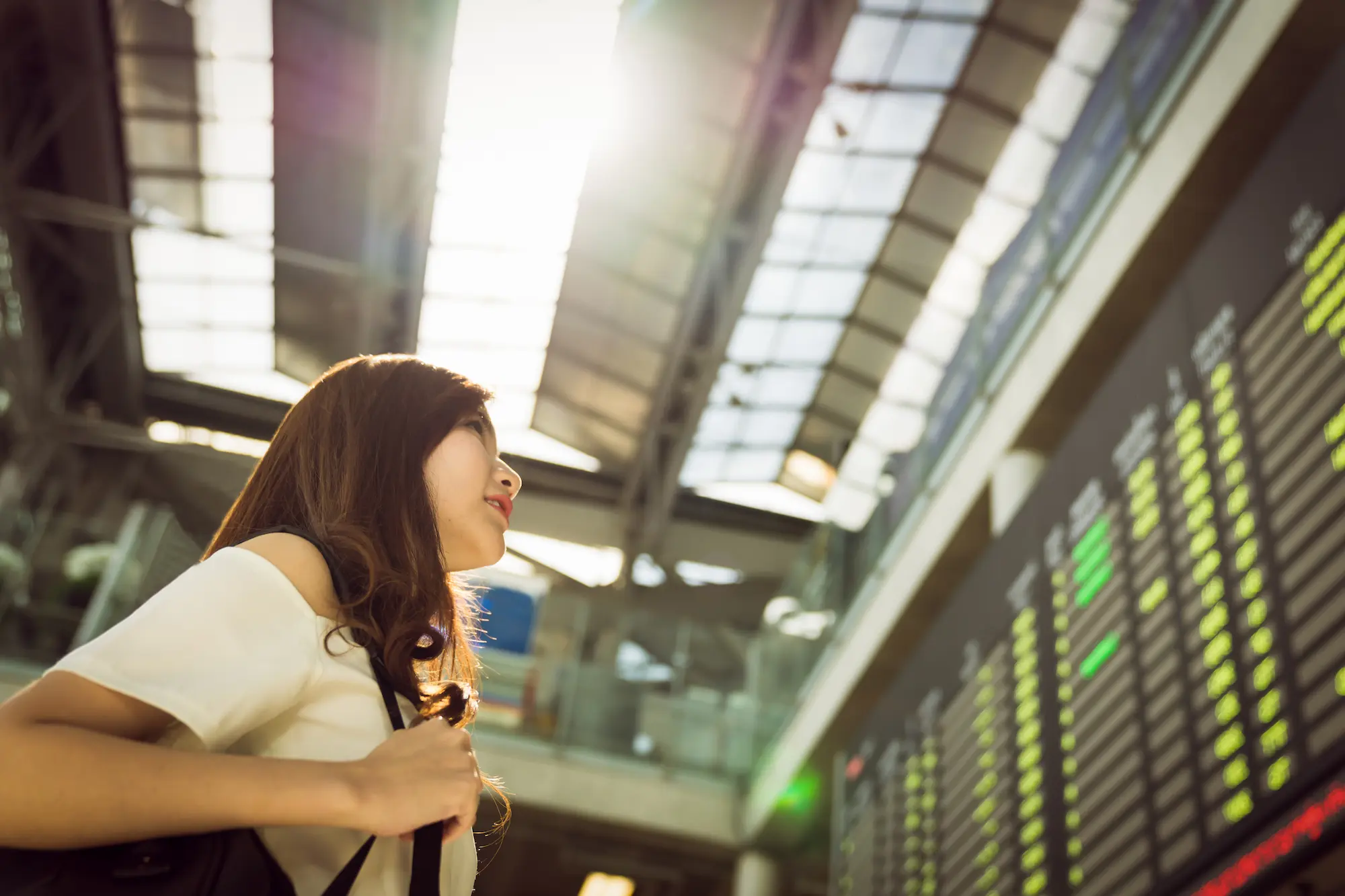 Traveller checking the airport flight information board