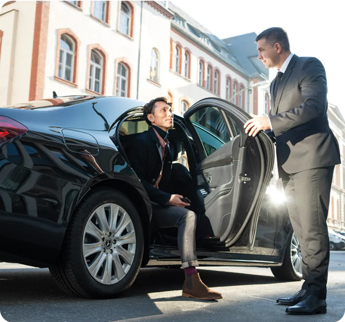 Chauffeur opening the door of an executive car